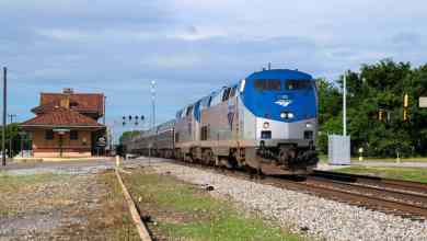 A photograph of a train leaving a train station.