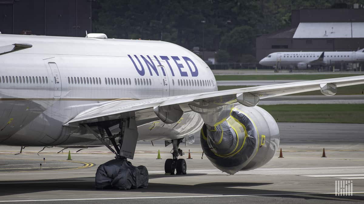 Close up of a white jet from behind the wing, jet is on the ground.