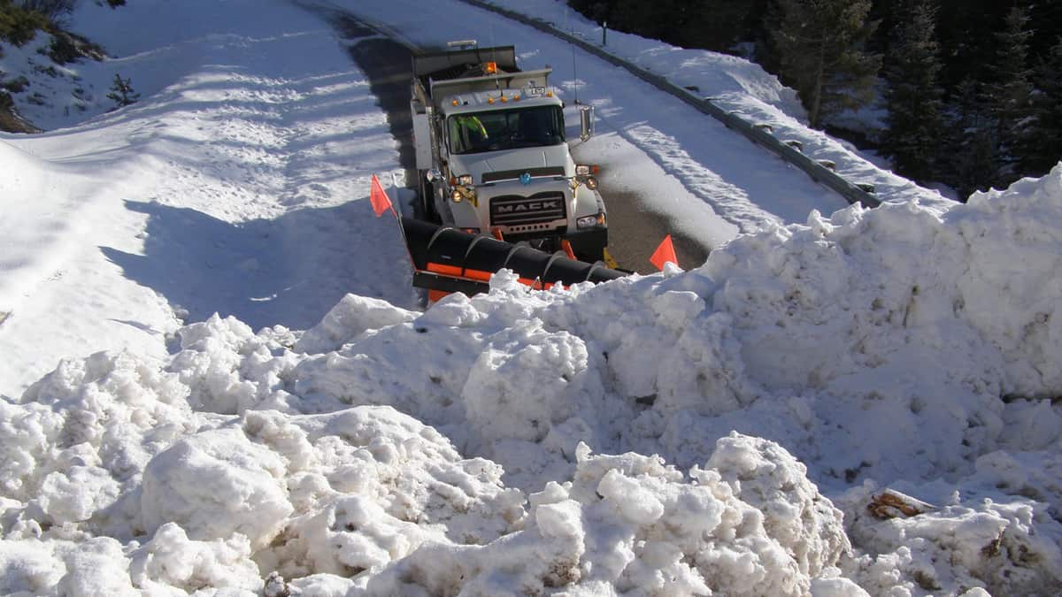 Plow clearing snowy highway in Idaho