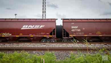A photograph of two railcars in a rail yard.