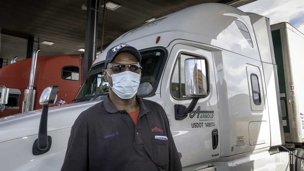 A truck driver uses personal protective equipment as he wears a medical face mask