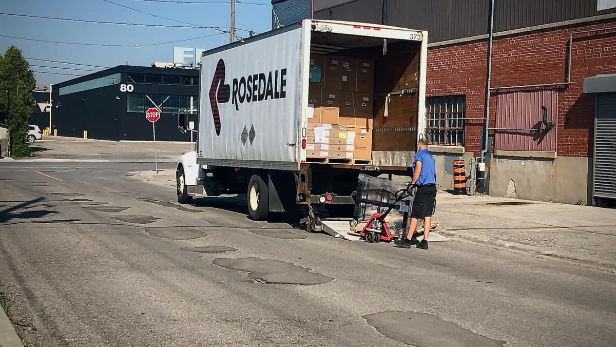 A driver unloads a truck in Toronto.