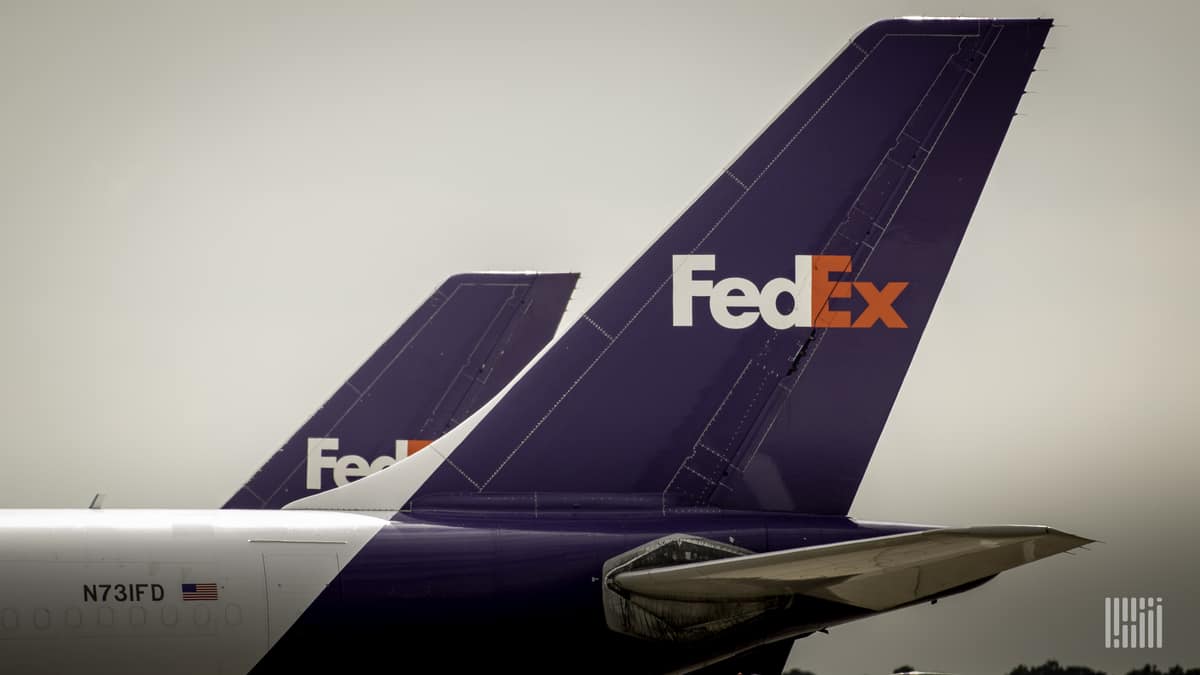 Close up of blue FedEx jet tails. FedEx pilots are upset about COVID health measures in Hong Kong.