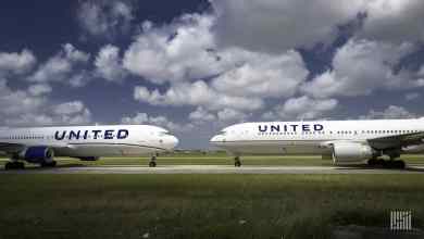 Two white United jets pointed nose-to-nose at each other. United Airlines is being cautious about adding aircraft to its schedule while the economy is still depressed.