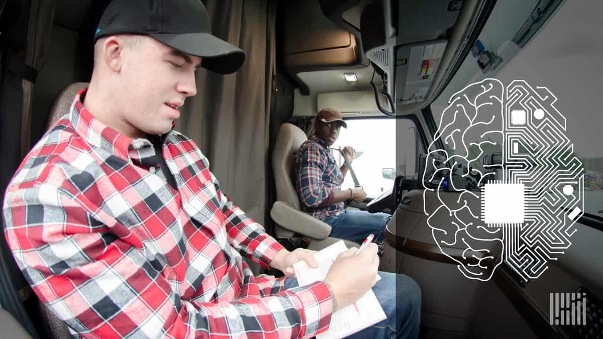 Two truck drivers working together in a truck cab.