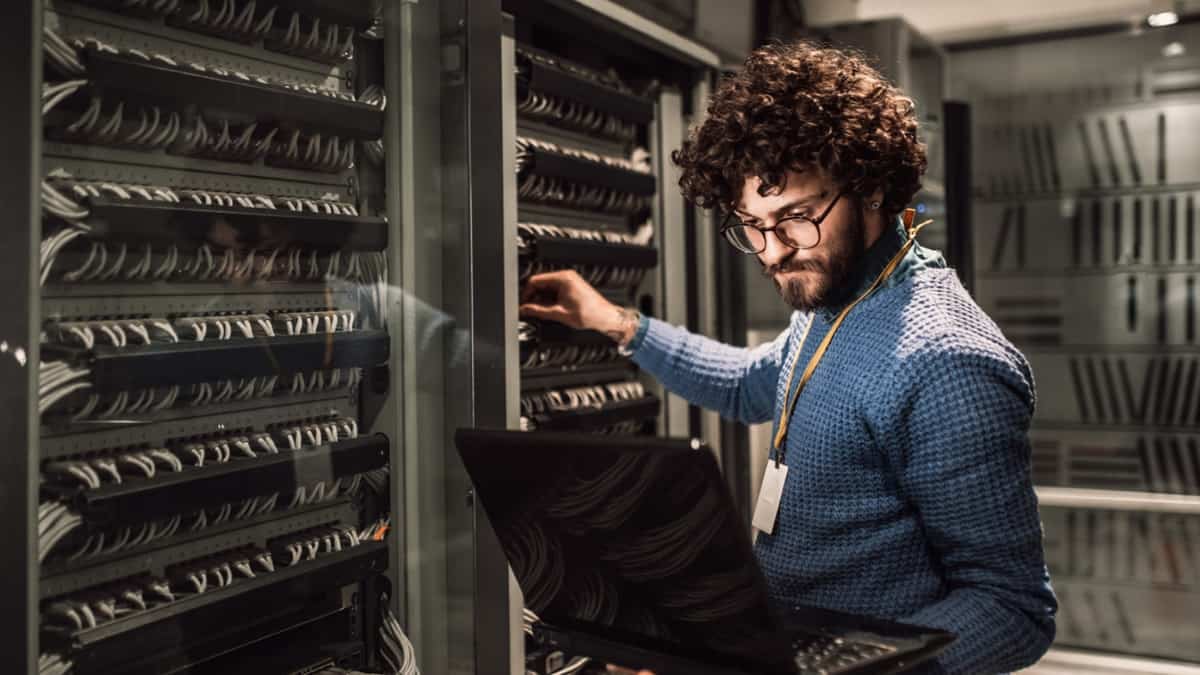 An IBM engineer works at a bank of servers...