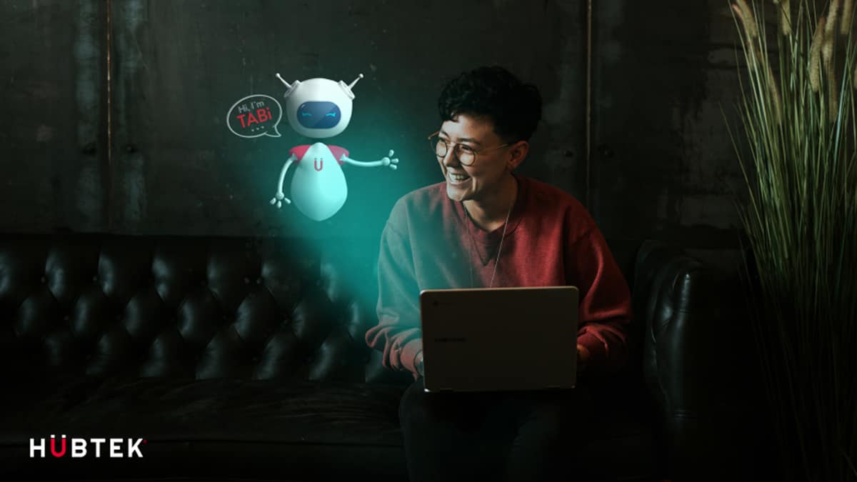 Worker sitting behind laptop with a cartoon bot