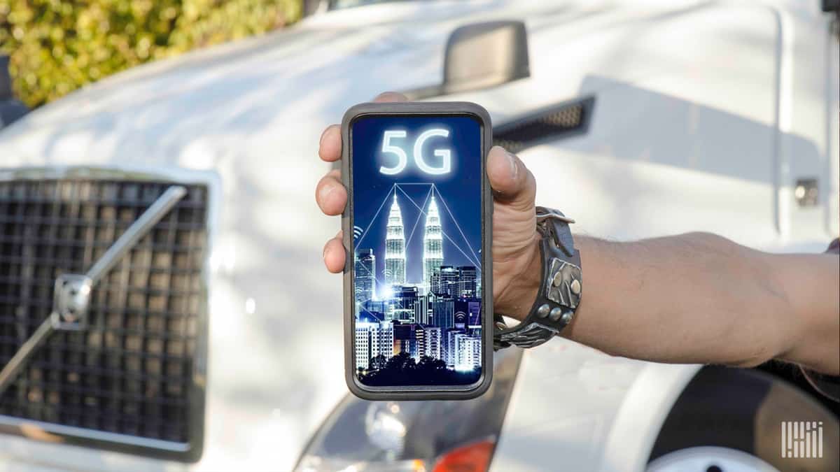 When will cellphones move from 4G to 5G? (Hand holding a cellphone with '5G' on picture.