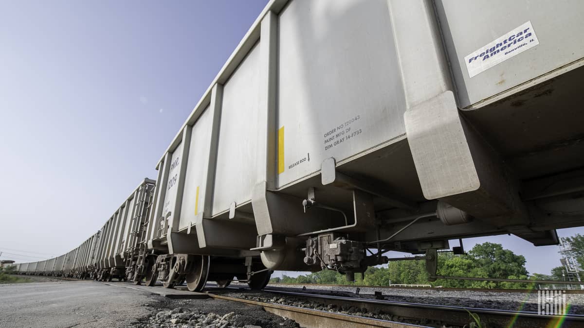 A photograph of a line of railcars parked in a rail yard.