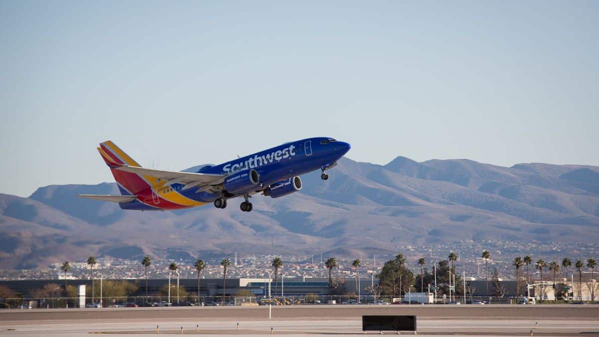 A Southwest Airlines jet pained in blue takes off at desert airport. Southwest posted a $1.5 billion second-quarter loss.