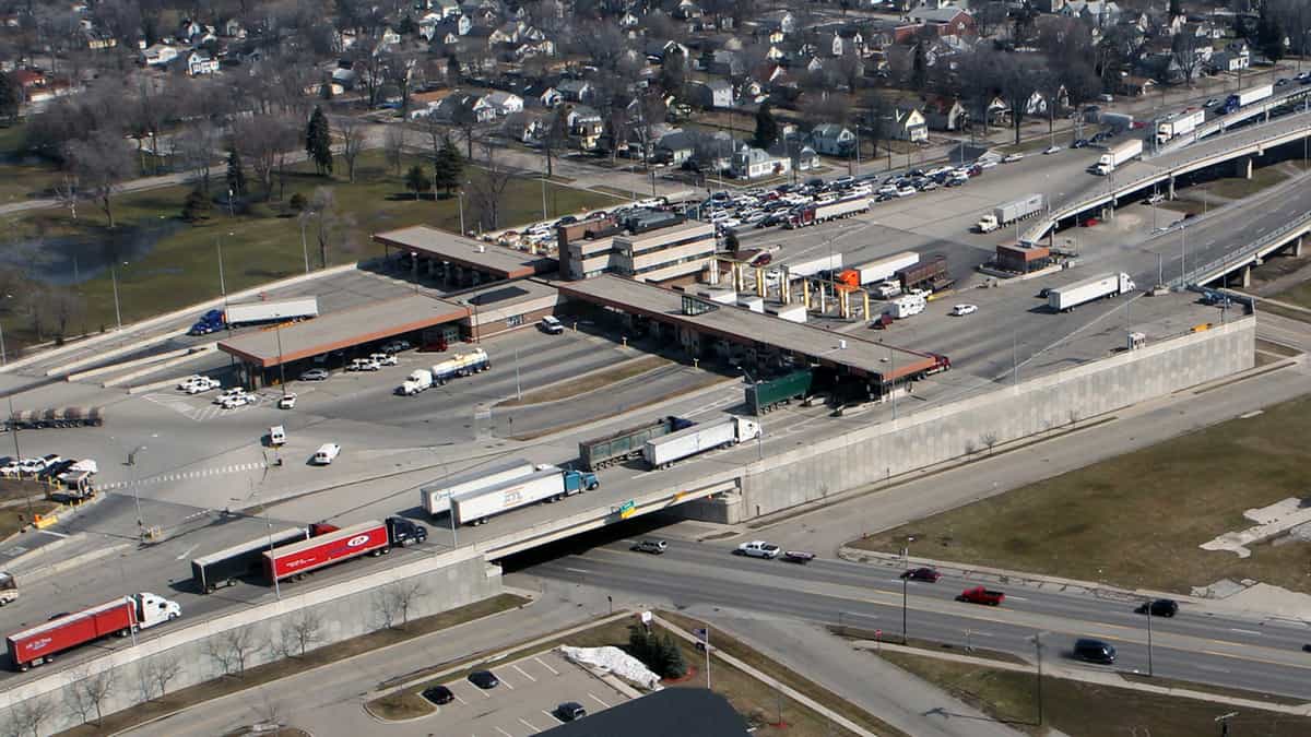 An aerial view of trucks at a U.S.-Canada border crossing. Truck crossings at the border have trended higher since April.