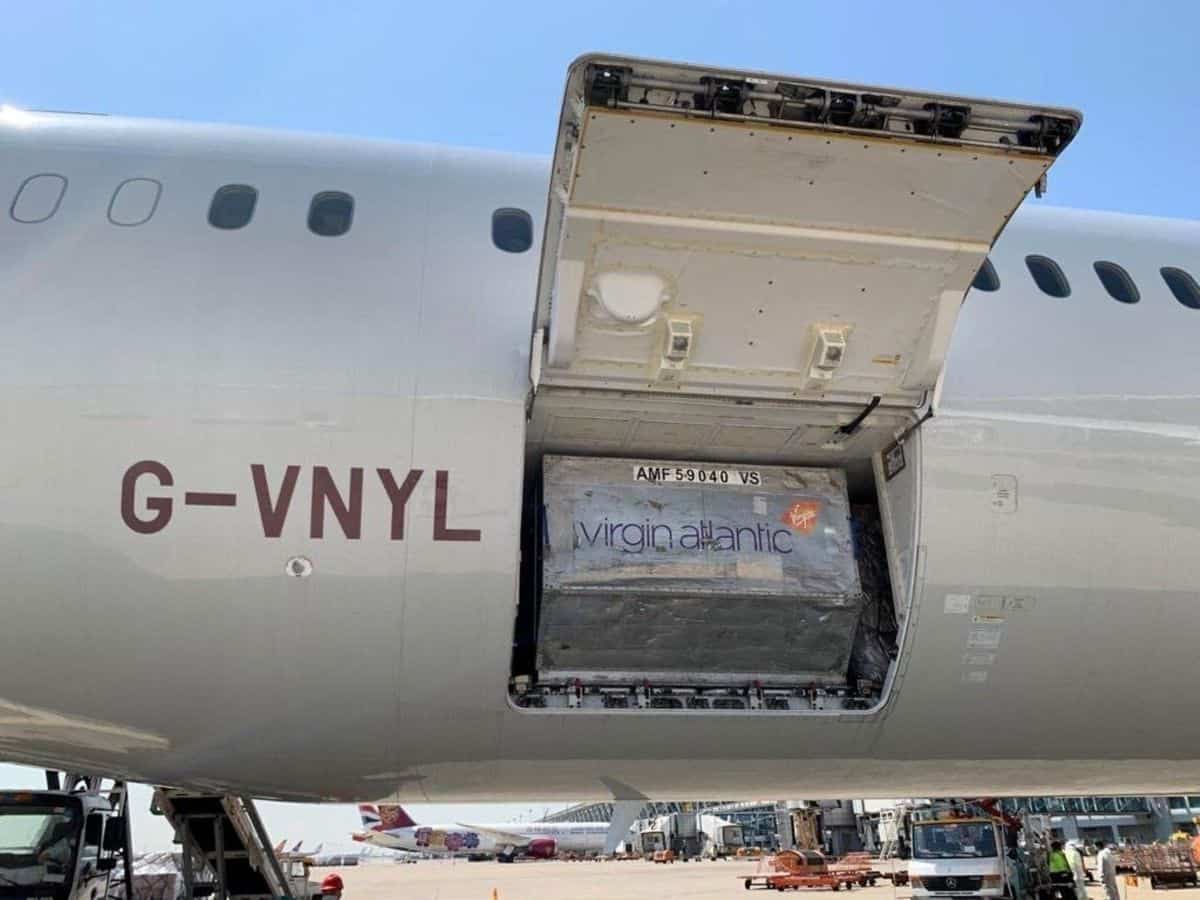 Cargo door open with a container resting in the hold of a Virgin Atlantic plane.
