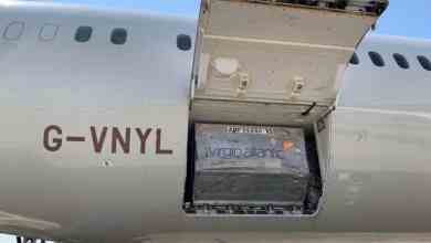 Cargo door open with a container resting in the hold of a Virgin Atlantic plane.