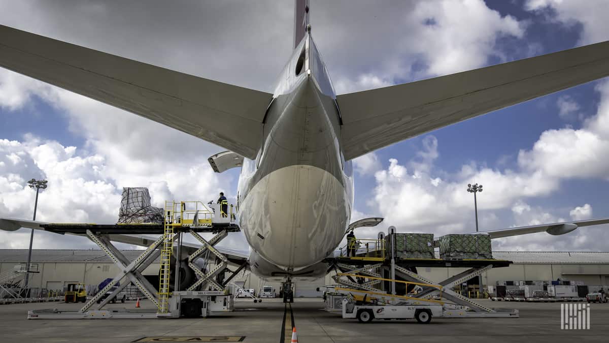 Cargo loading on a big jet as viewed from behind the tail, close up.