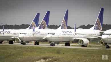 White jets with blue tails from United Airlines lined up on an inactive taxiway at George Bush Intercontinental Airport in Houston. They're in storage.