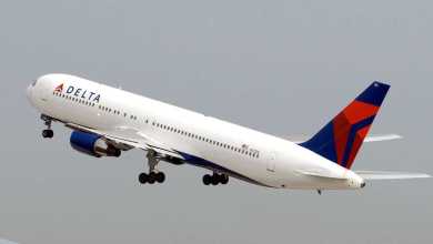 A big white Delta jet with blue tail early in takeoff. Delta wants to take out some seats in planes to make way for cargo.