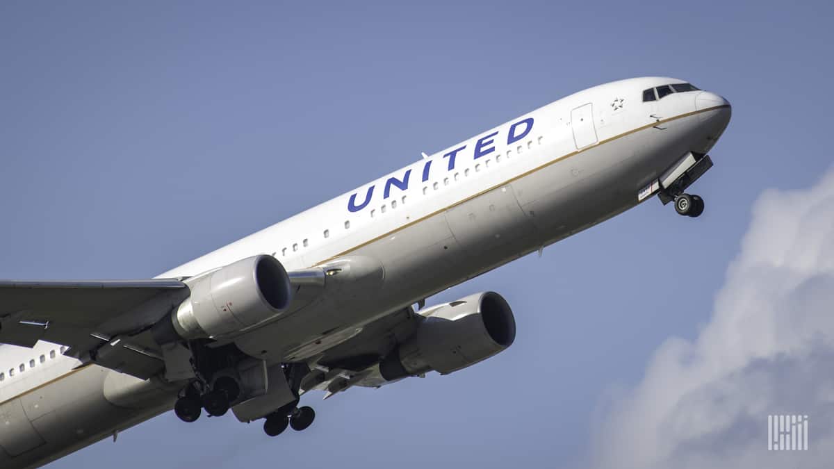 A white United Airlines planes takes off into bright blue sky. United is adding more flights between San Francisco and Shanghai.