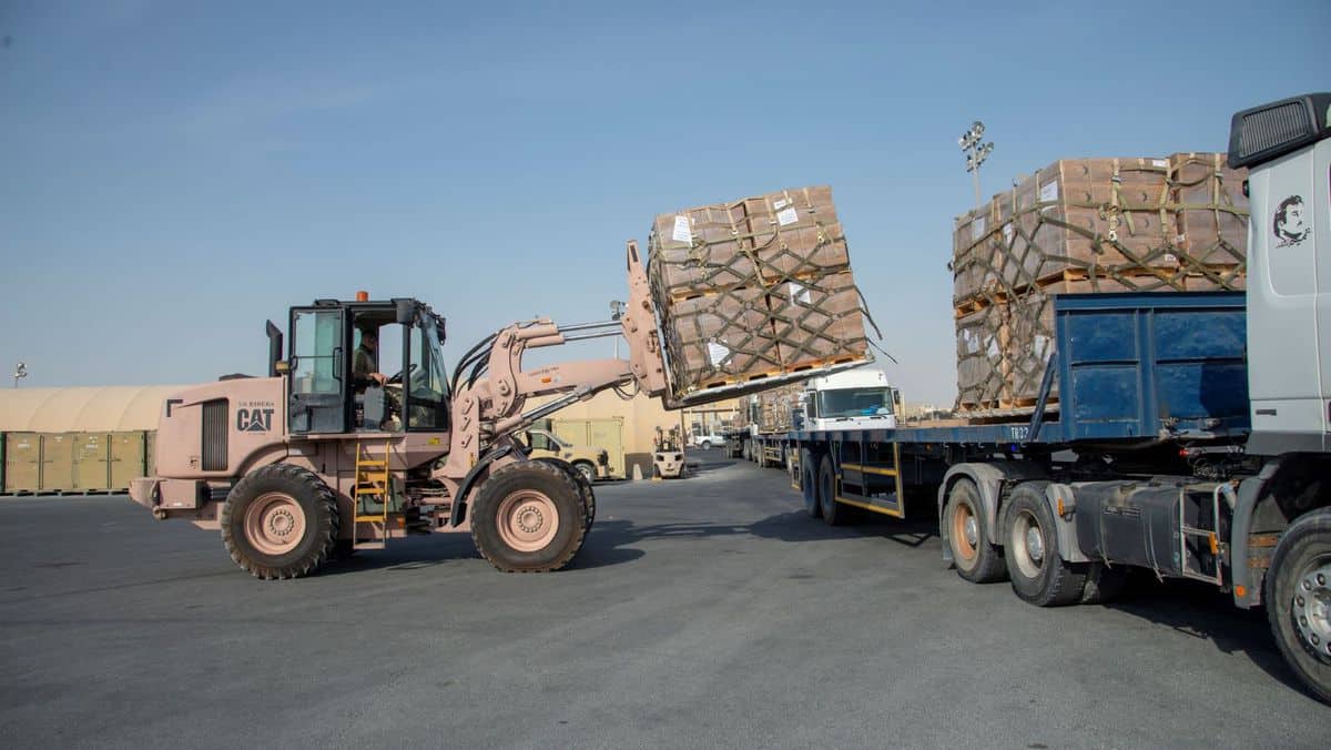 U.S. military fork lift puts pallets on a truck as part of airlift of relief supplies to Beirut, which is suffering the effects of a huge explosion at the port.