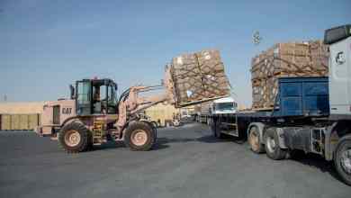 U.S. military fork lift puts pallets on a truck as part of airlift of relief supplies to Beirut, which is suffering the effects of a huge explosion at the port.