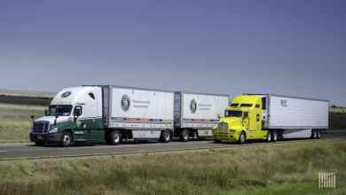 Old Dominion double next to truckload rig on highway