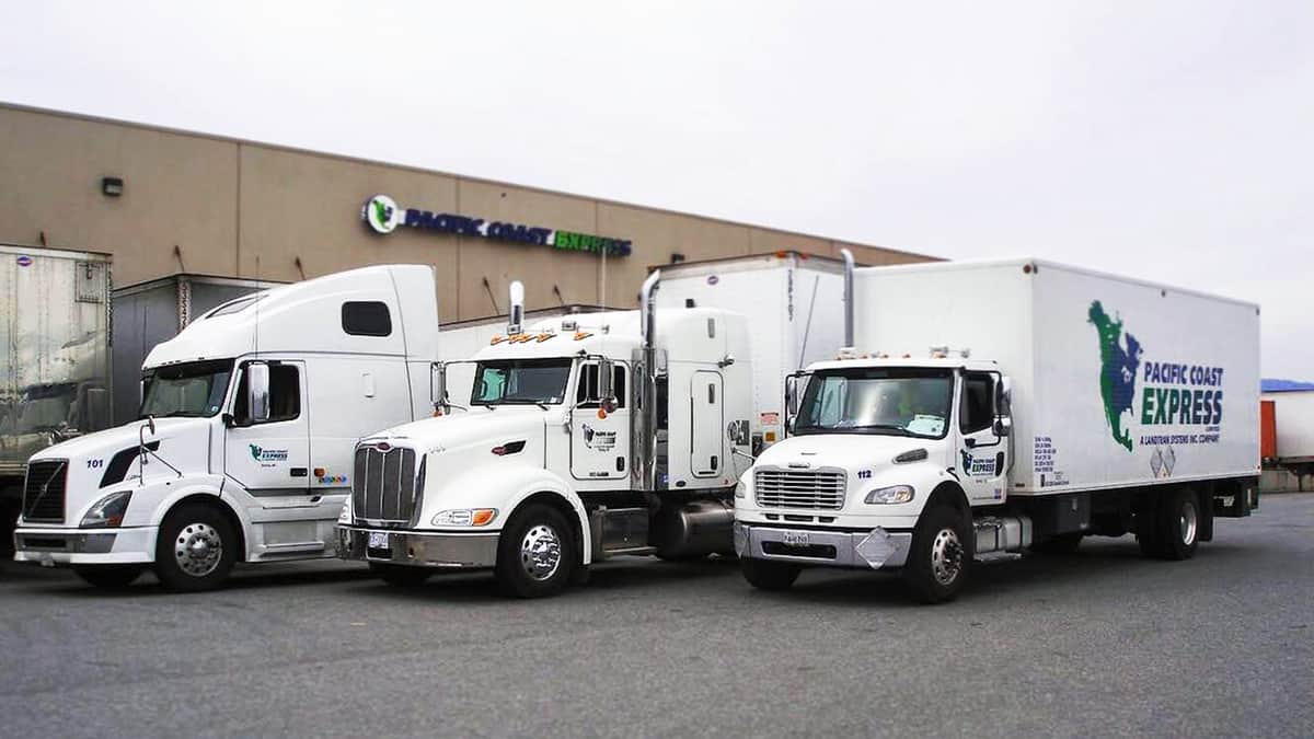 Three parked trucks from Pacific Coast Express, a Canadian less-than-truckload carrier recently acquired by Mullen Group.