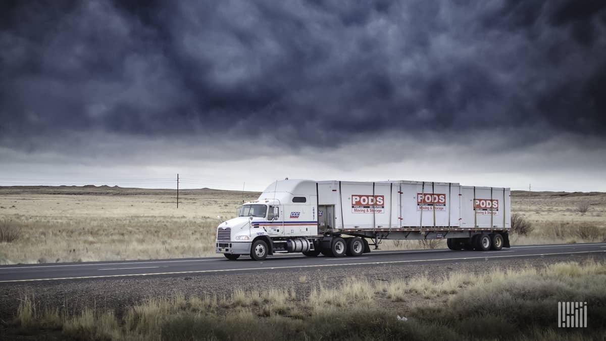 A tractor-trailer of CCC Transportation drives on a road. TFI International has acquired CCC from Comcar Industries.