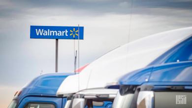 Trucks in front of a Walmart facility. Walmart Canada says a blockchain payment platform had dramatically reduced invoice disputes.