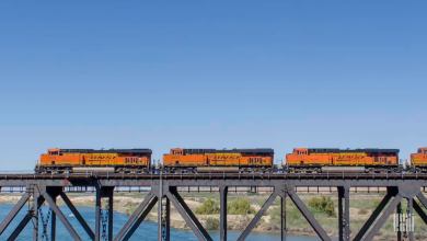 A photograph of three BNSF locomotives crossing a bridge.