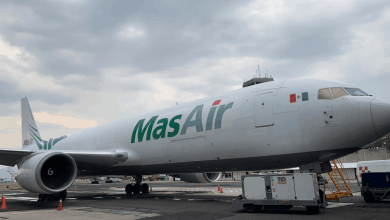 A white cargo jet parked, waiting for a load.
