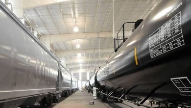 A photograph of tank cars parked inside a garage.
