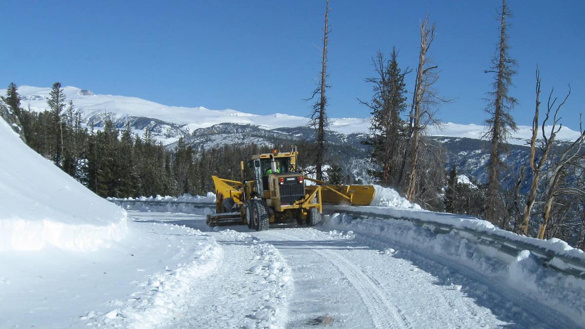 Plow clearing a snowy Montana highway.