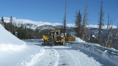 Plow clearing a snowy Montana highway.