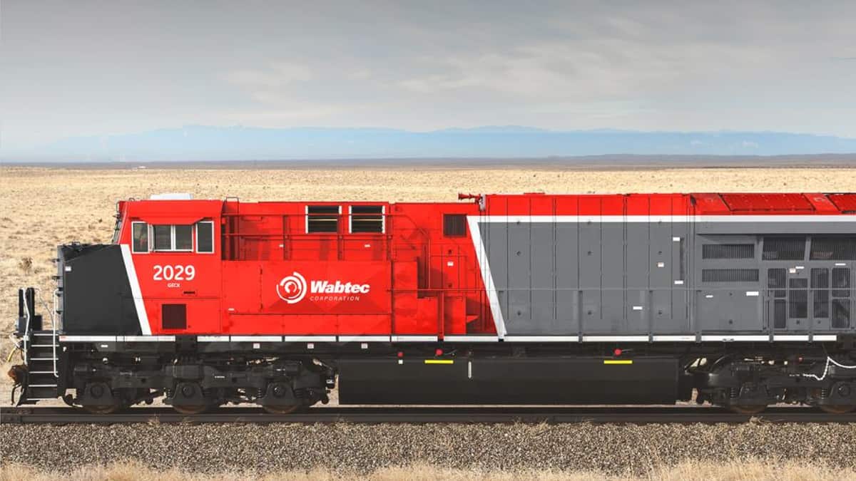 A photograph of a train traveling through a wheat field.