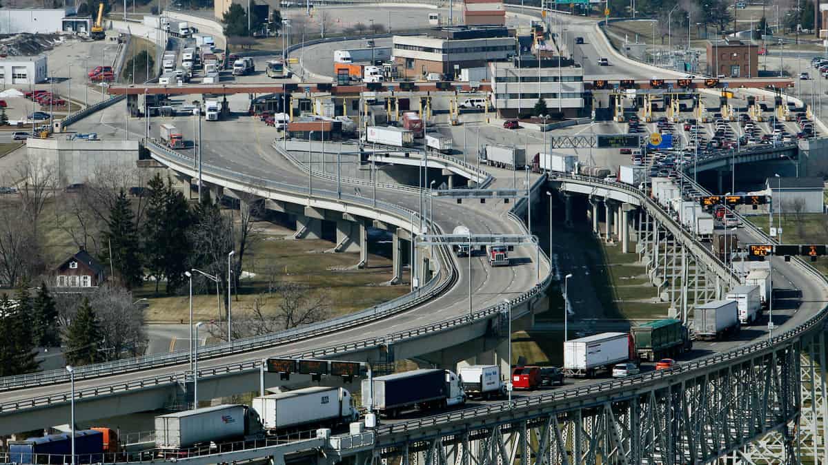 Trucks cross the the U.S.-Canada border. The US election could impact cross-border trade.