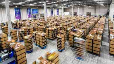 Stacks of boxes on robot sleds in warehouse.