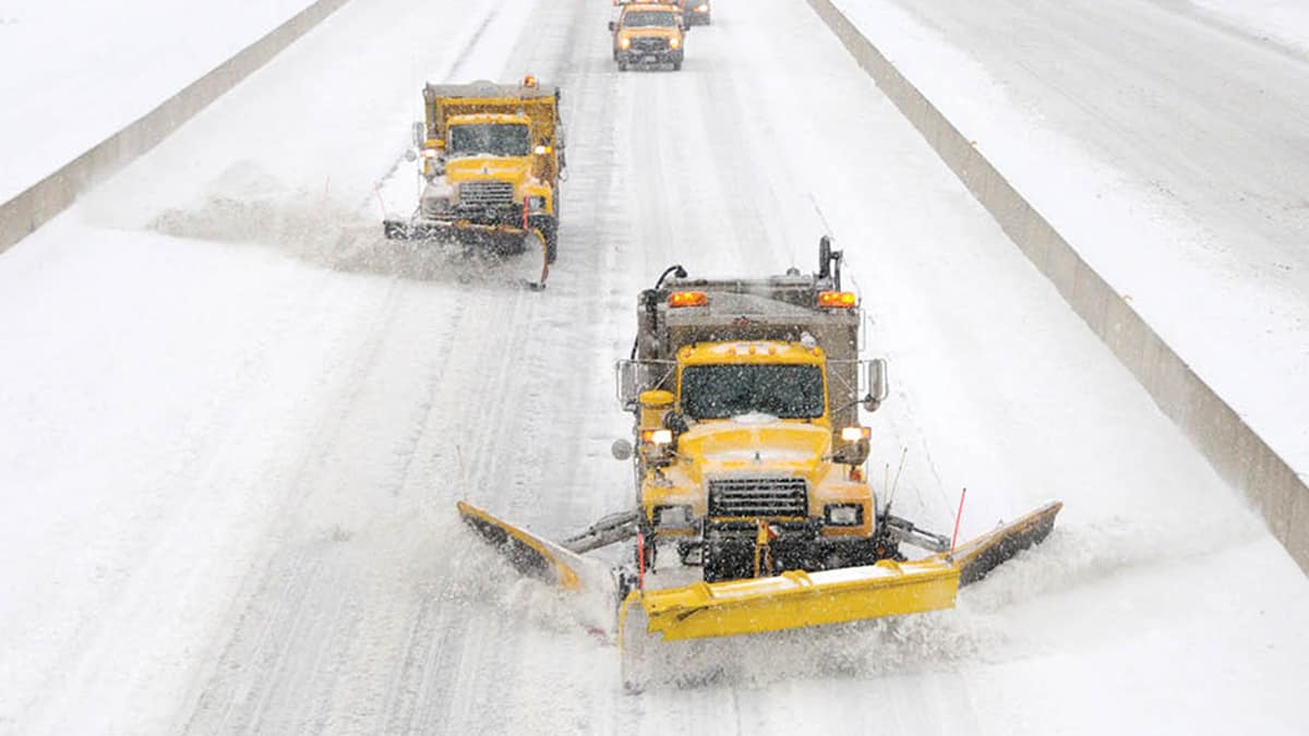 Plows clearing a snowy Pennsylvania highway.