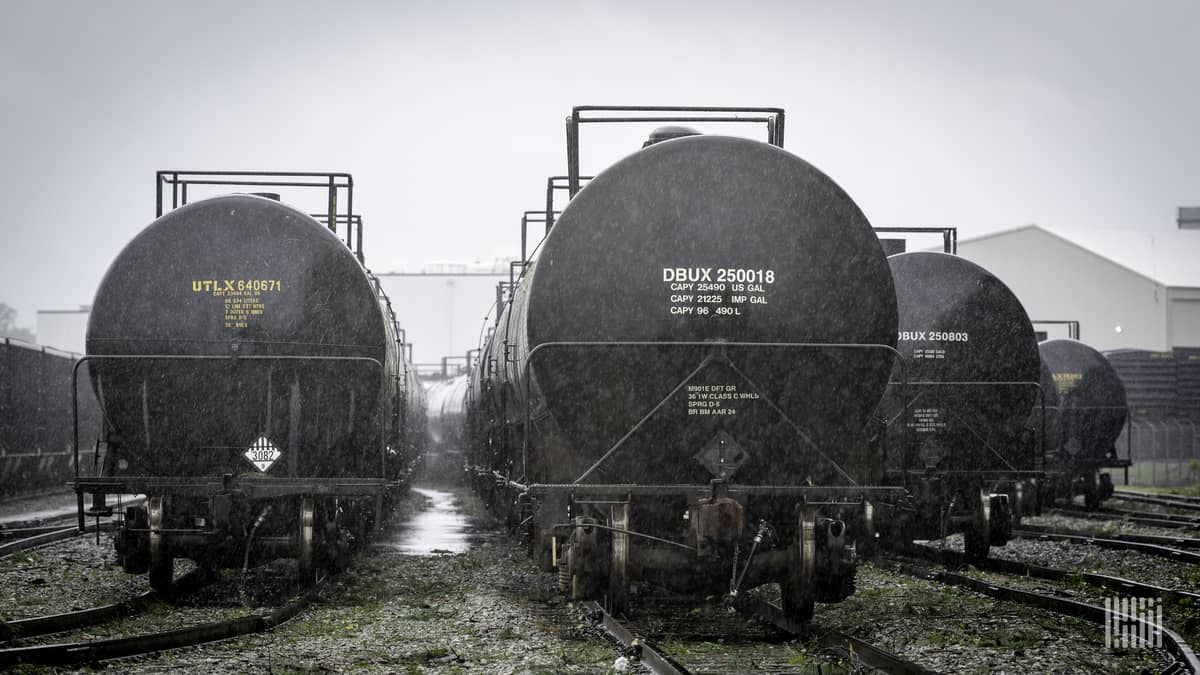 A photograph of tank cars parked in a rail yard.