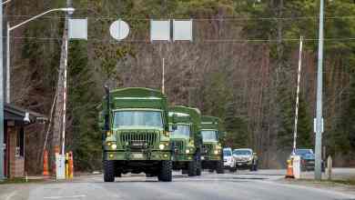 A convoy of military vehicles enters Canadian Forces Base Borden. The Canadian Armed Forces will be helping distribute COVID-19 vaccines.