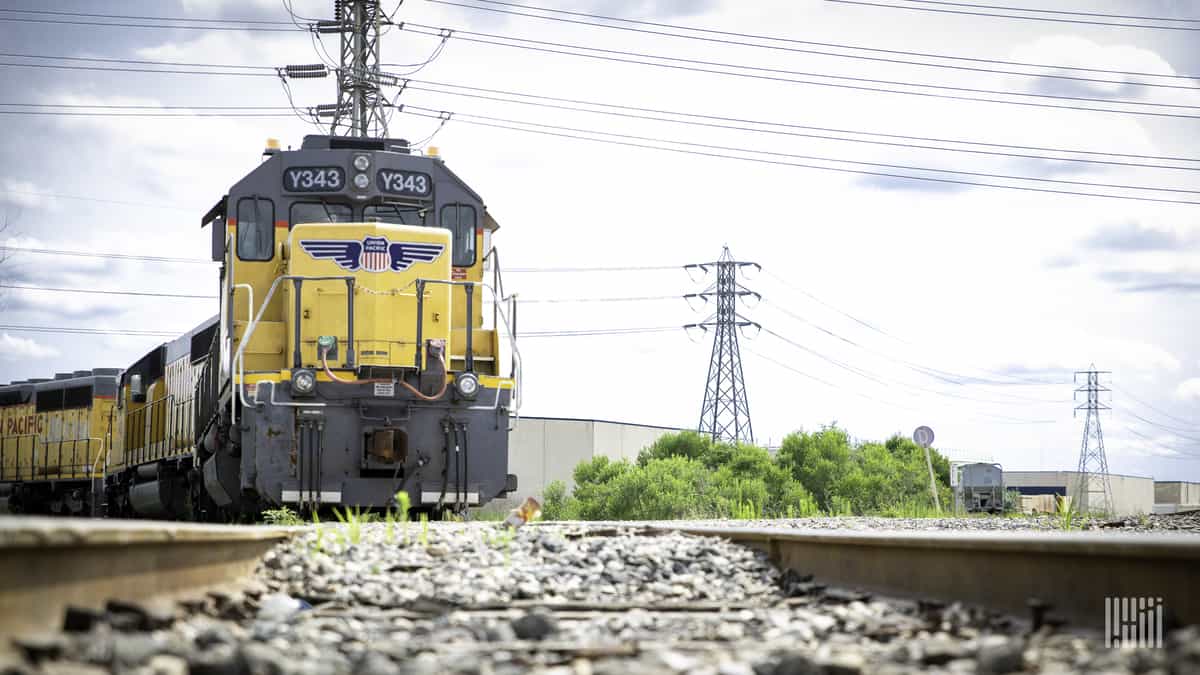 A photograph of a Union Pacific train traveling from a rail yard.