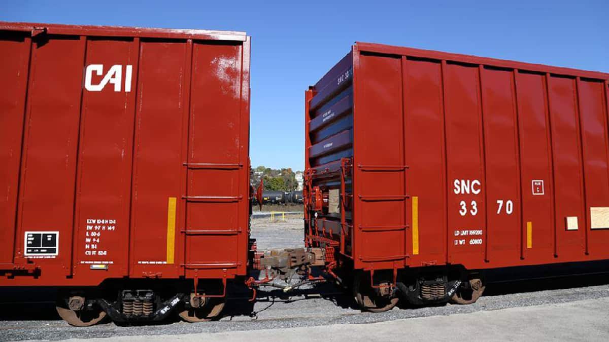 A photograph of two railcars on a train track.