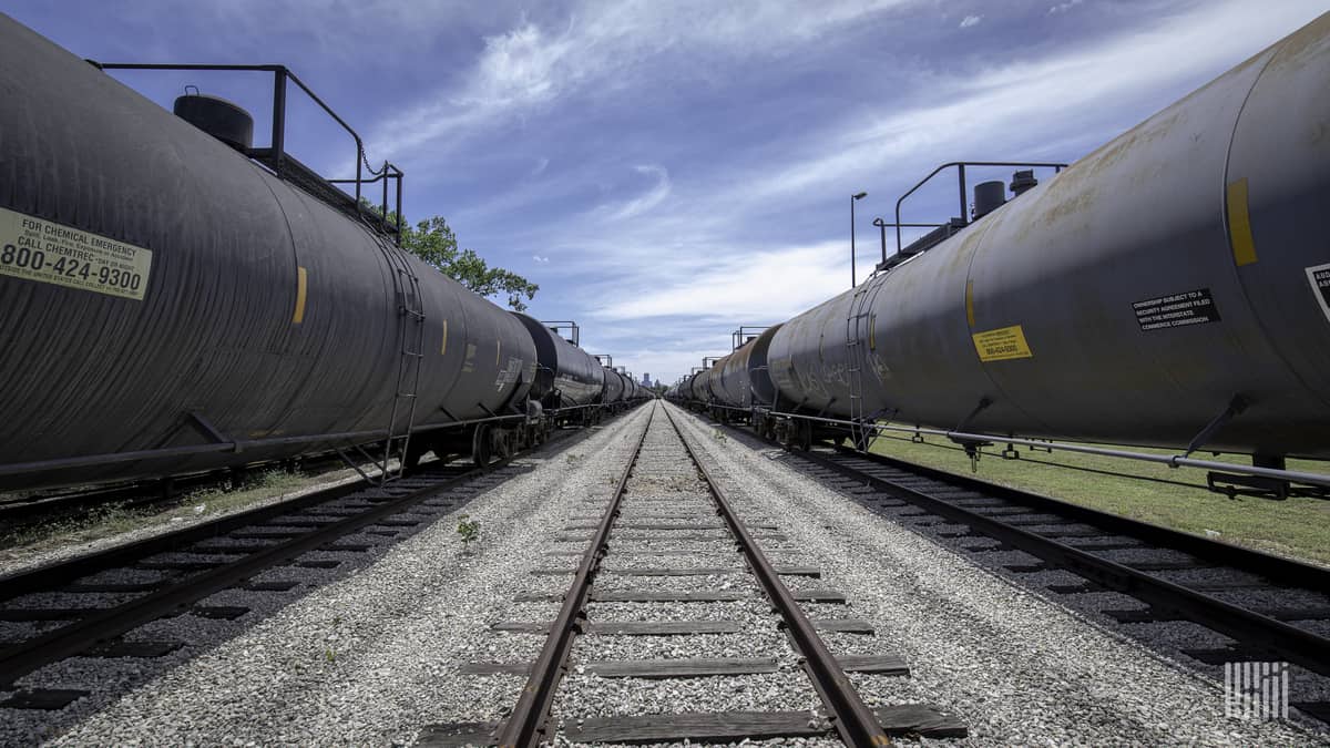 A photograph of tank cars parked in a rail yard.