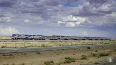 A photograph of an Amtrak train traveling across a grassy field.