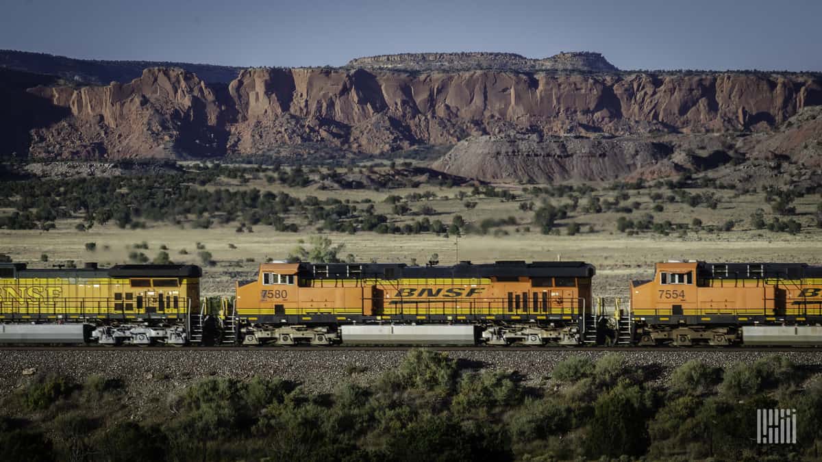 A photograph of a BNSF moving across a field.
