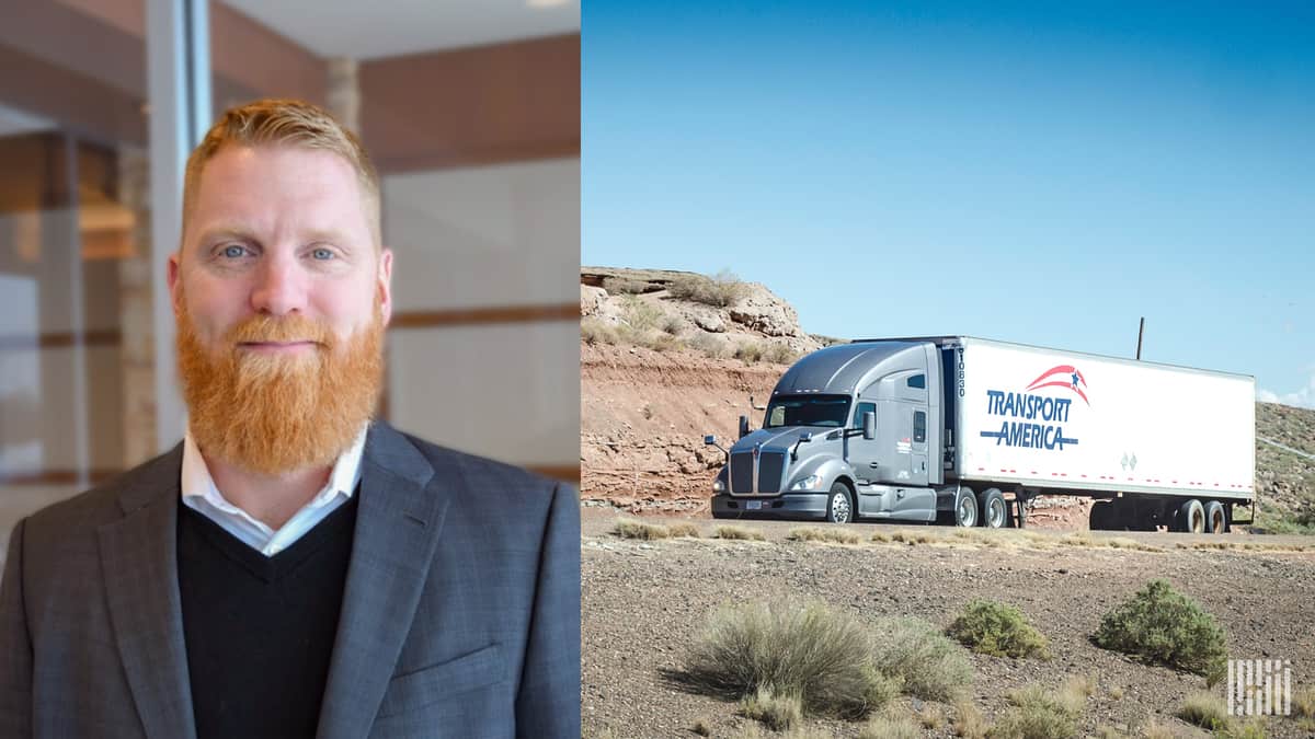 Transport America President Eric Anson shown next to a Transport America tractor trailer. The trucking company has been shifting its drivers to dedicated trucking services.