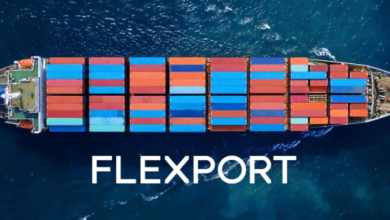 Container vessel image looking down from the air. Flexport logo on the water.