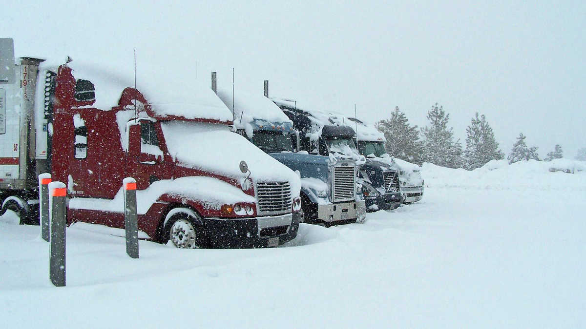 Tractor-trailers parked during a California snowstorm.