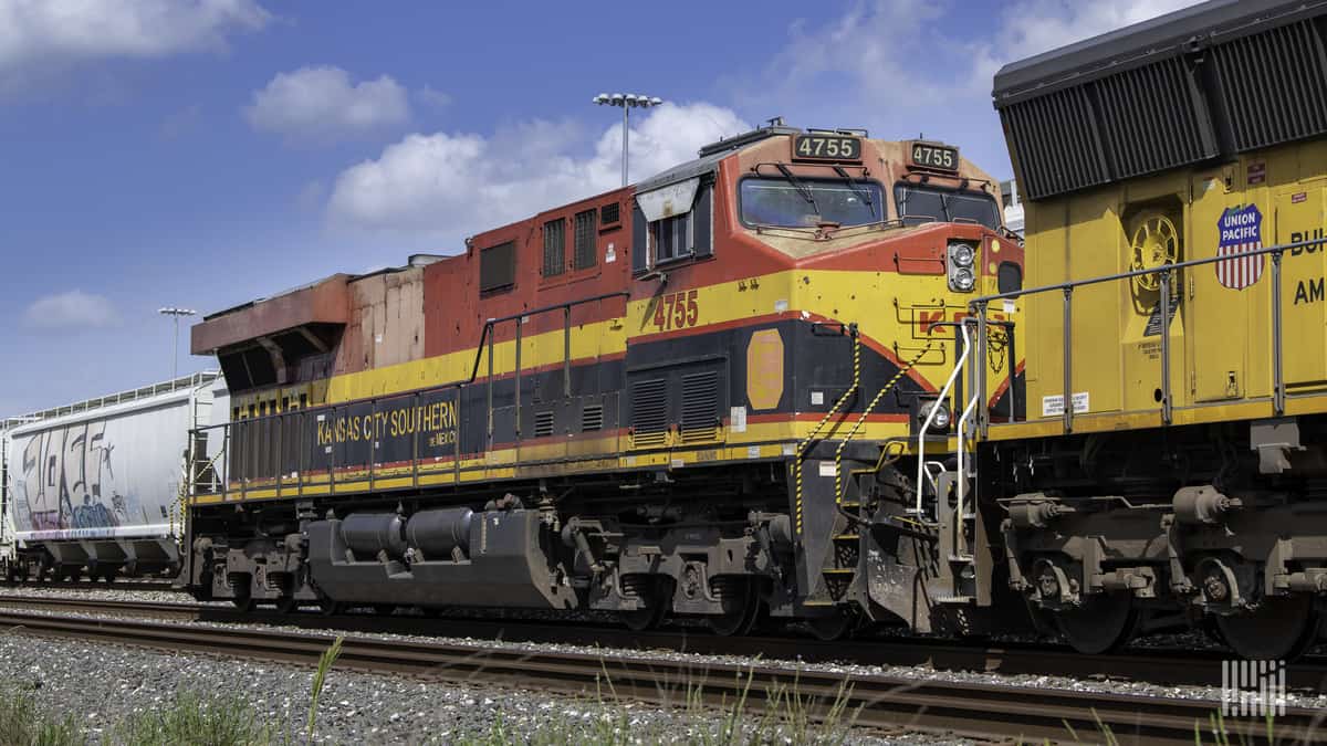 A photograph of a Kansas City Southern train in a rail yard.