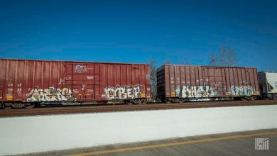 A photograph of boxcars in a rail yard.