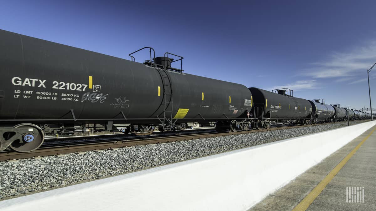 A photograph of tank cars parked at a rail yard.