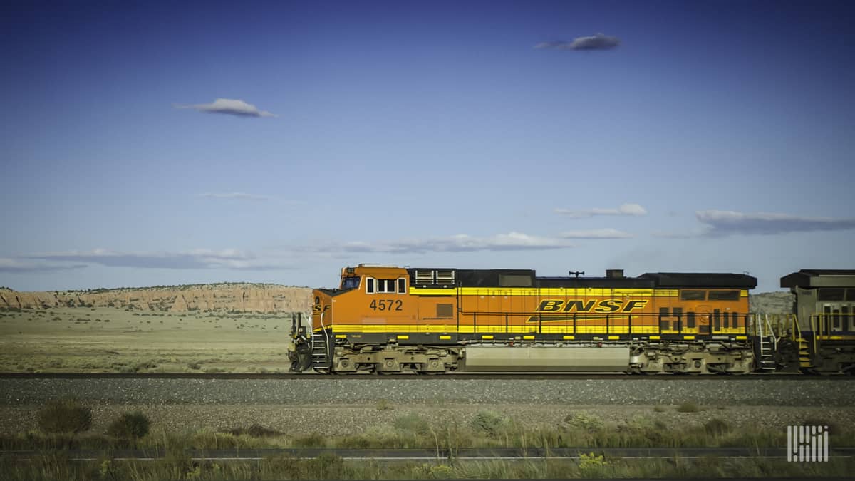 A photograph of a BNSF locomotive crossing a field.